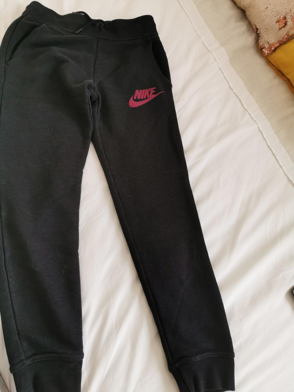 grey nike joggers with red tick