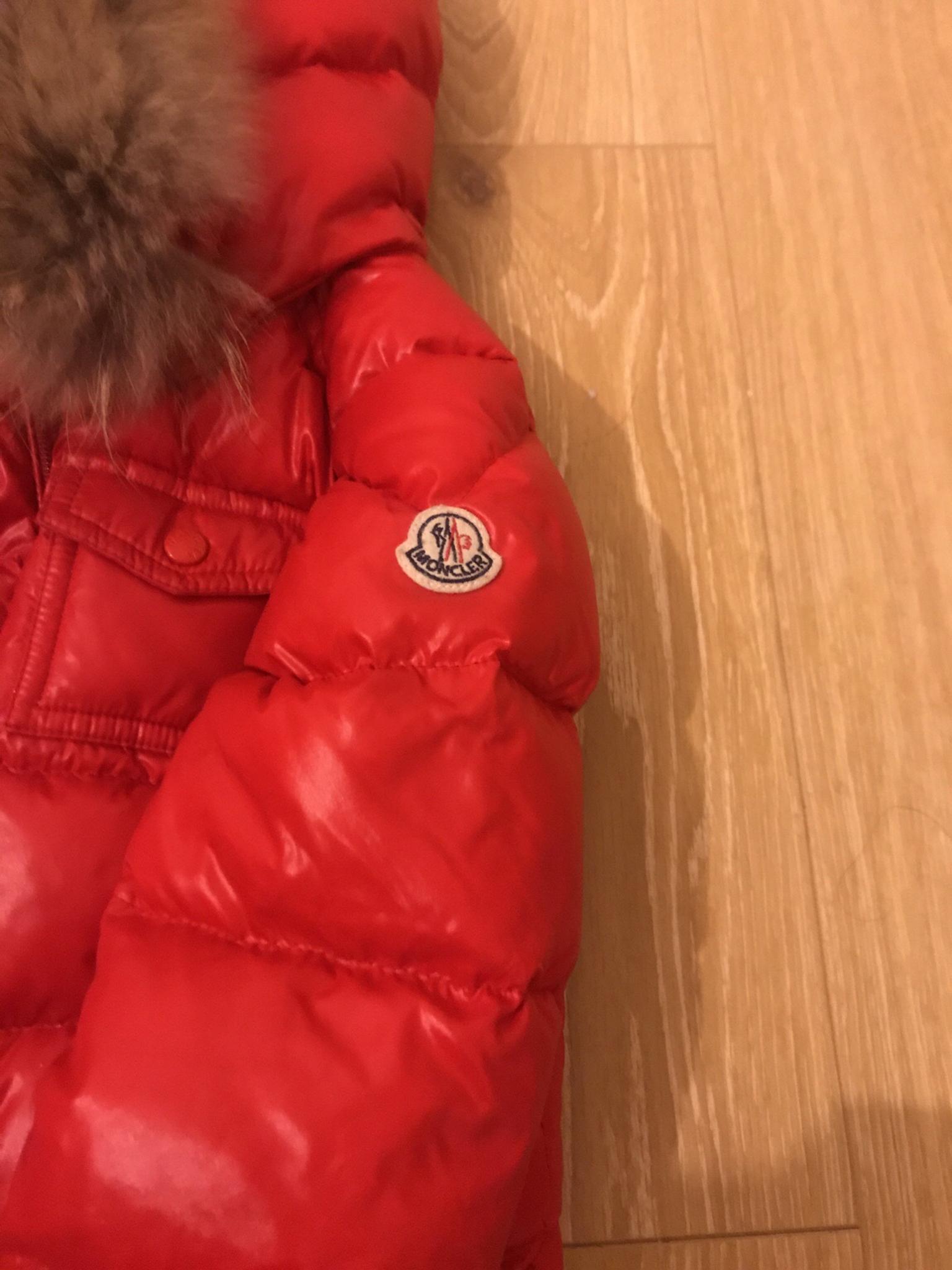 red moncler coat with fur hood