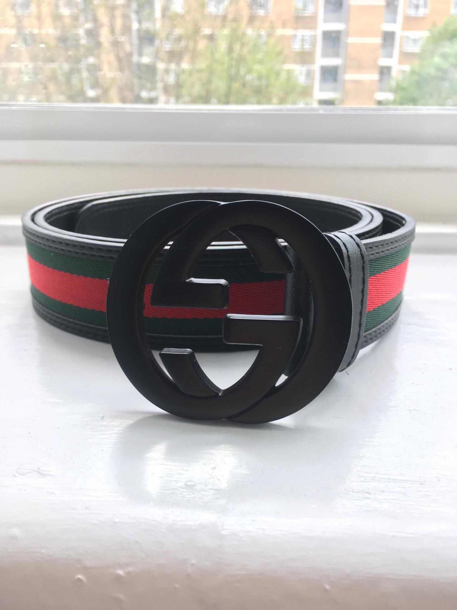 black gucci belt with red stripe