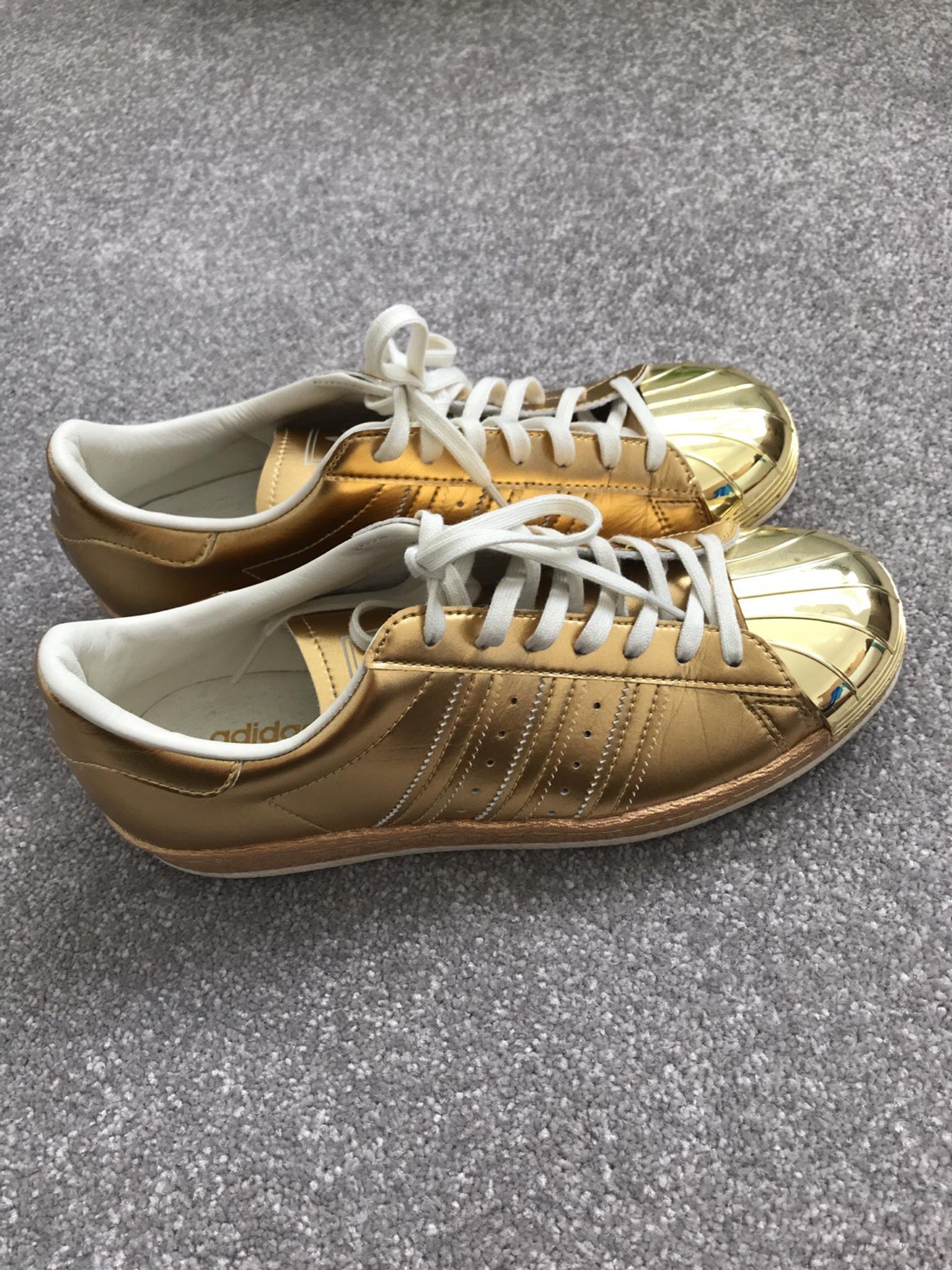 gold adidas trainers