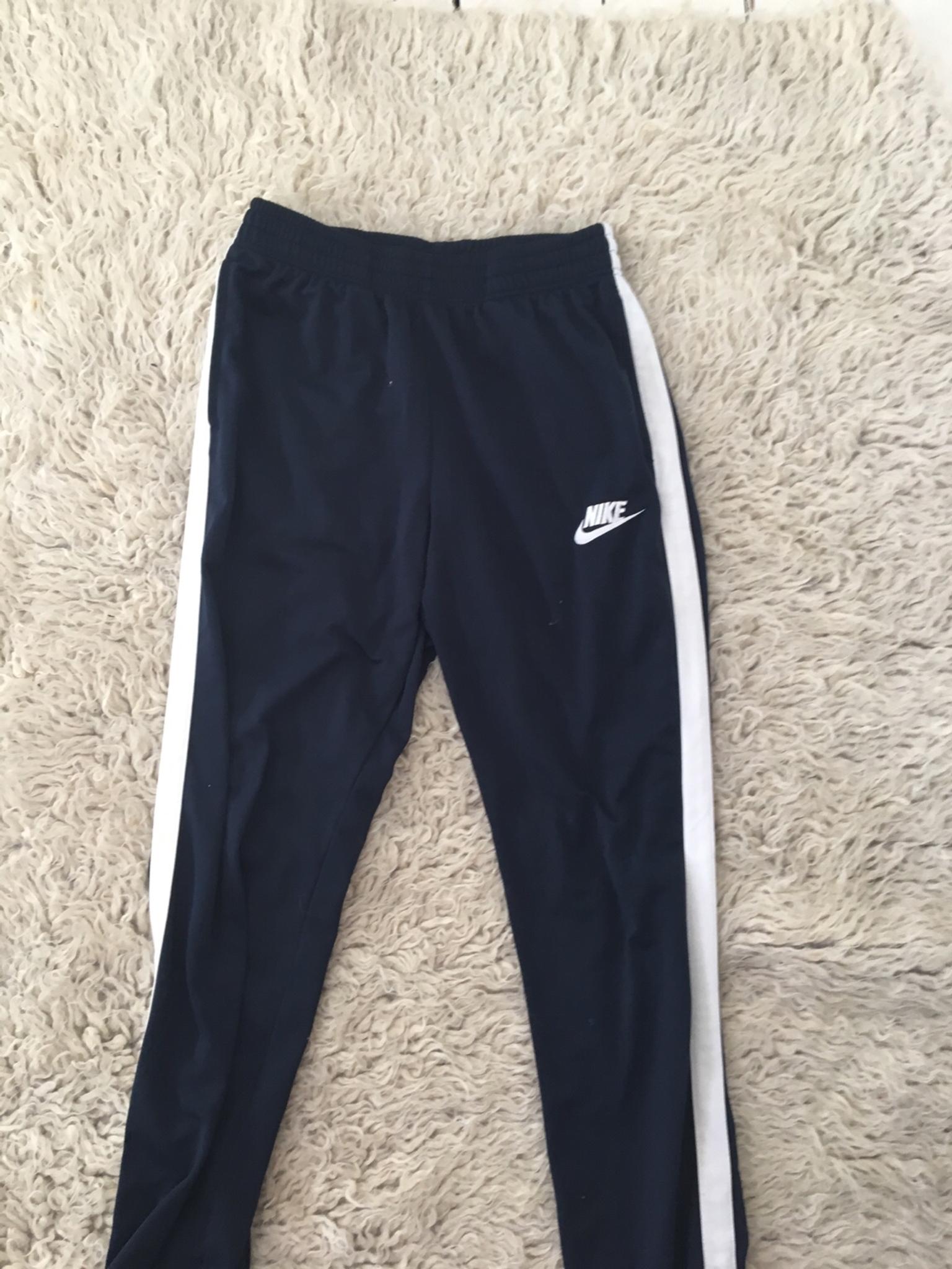 black tracksuit bottoms with white stripe