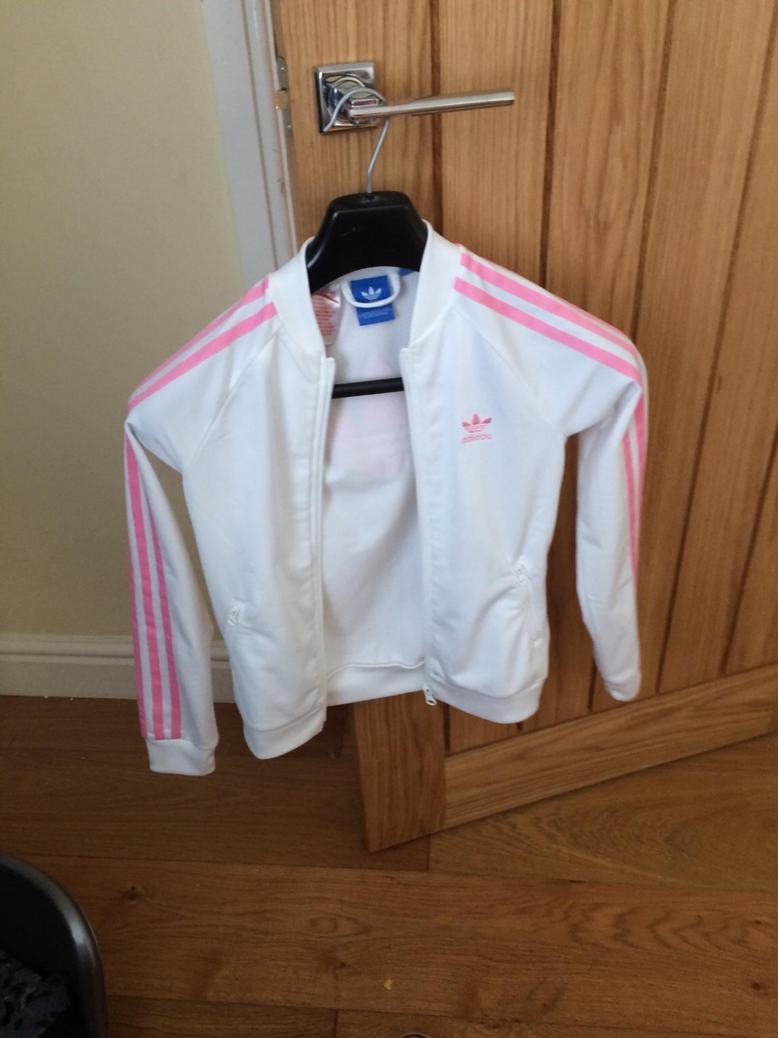 pink adidas jacket with white stripes