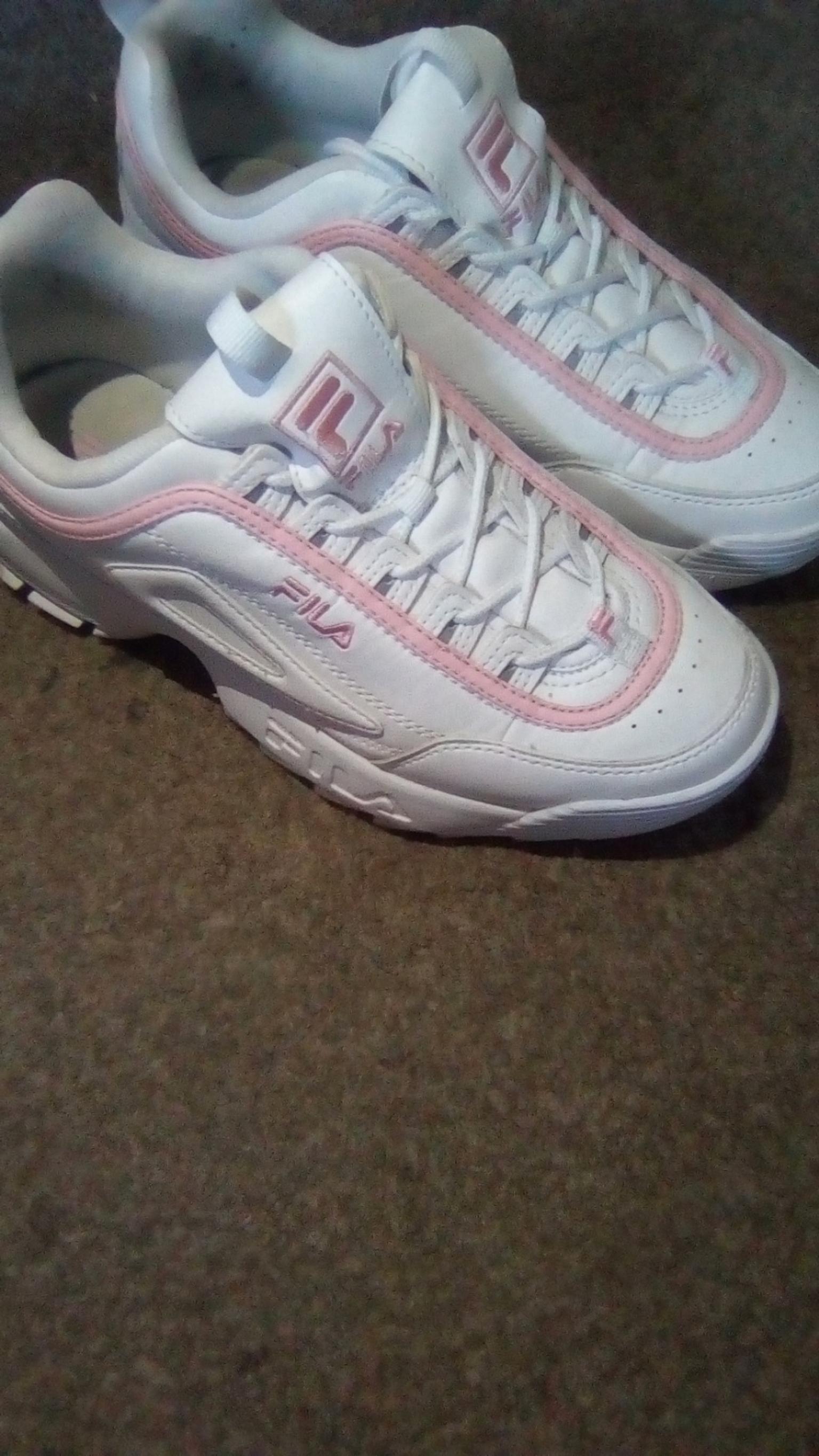 white and pink fila trainers