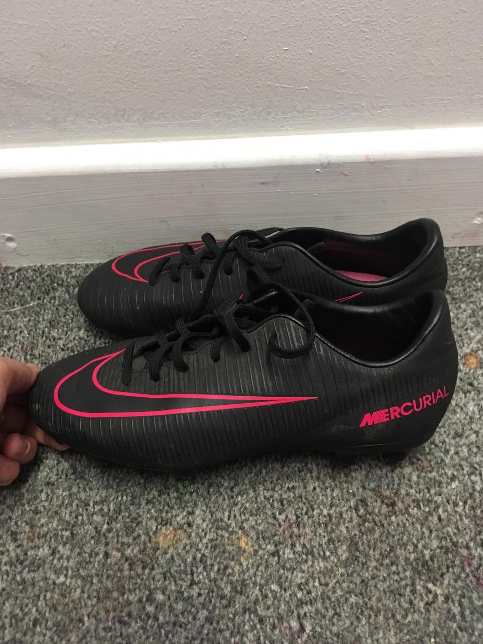 black and pink nike boots