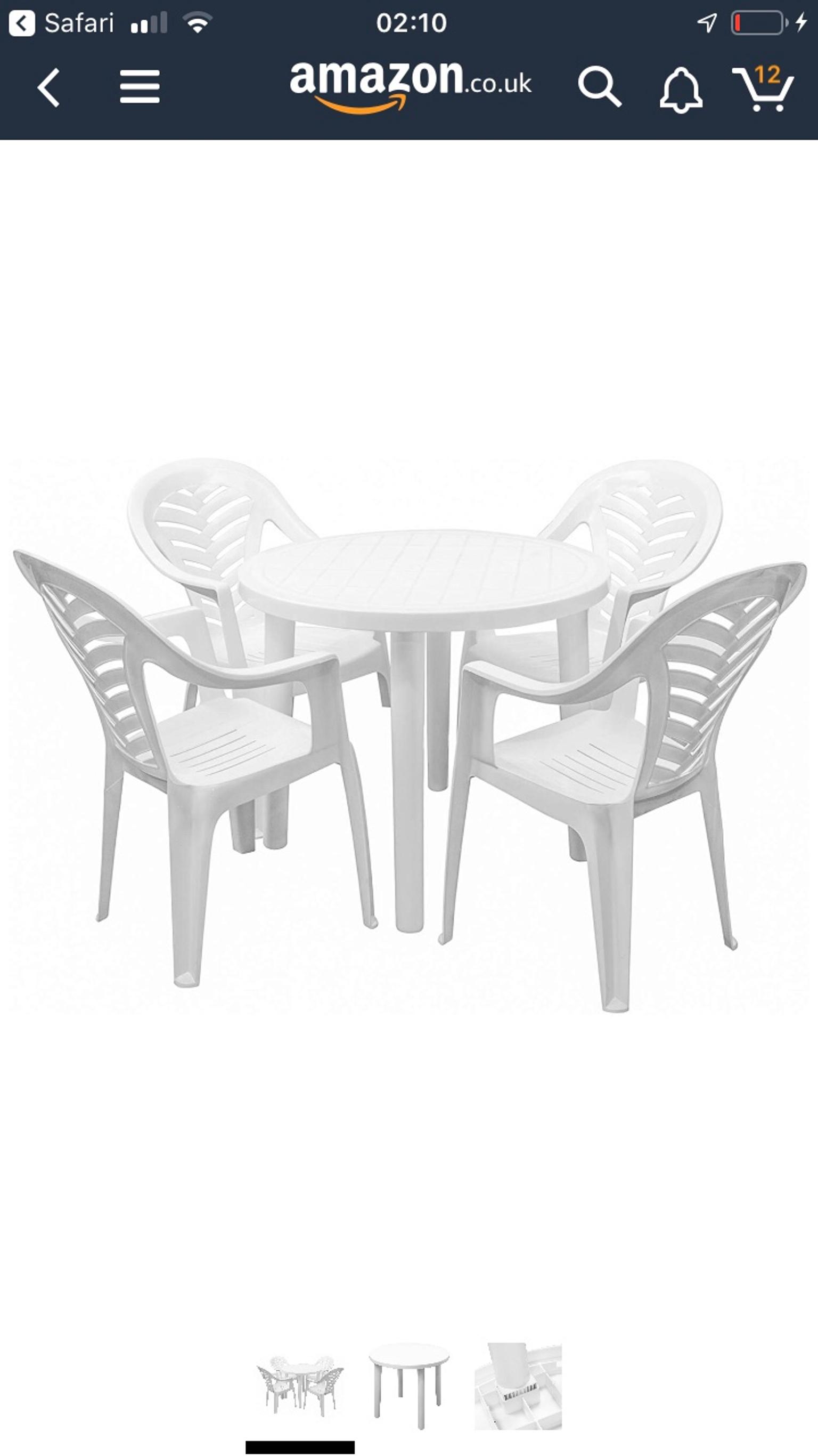white plastic garden chairs and round table