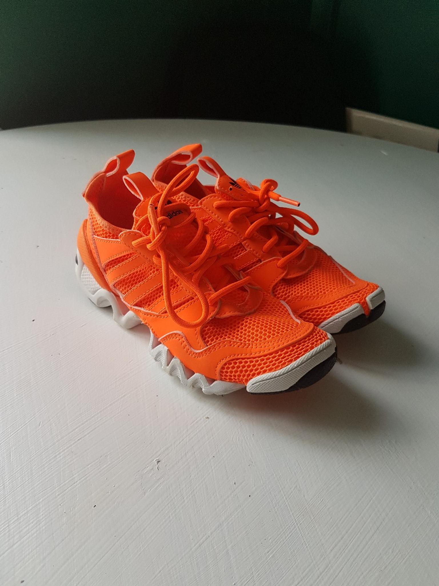 bright orange adidas trainers